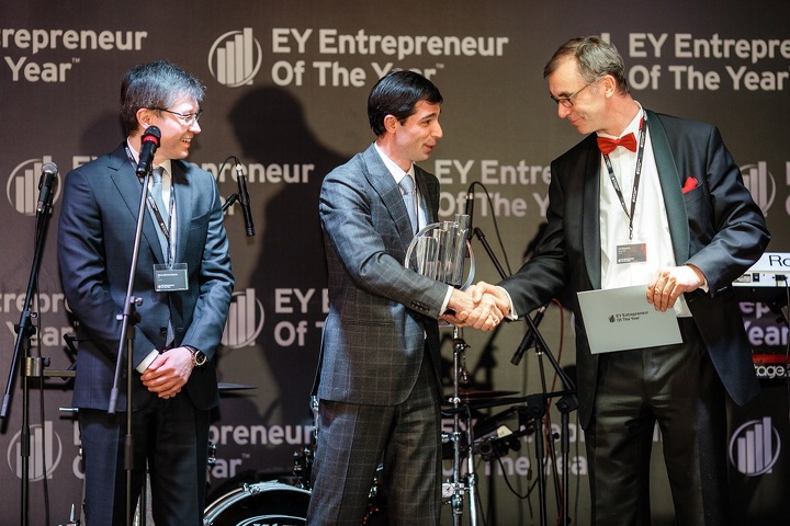 Управляющий партнер EY Ерлан Досымбеков и член независимого жюри конкурса Ульф Вокурка награждают национального победителя 2014 года Андрея Лаврентьева (торжественная церемония в городе Алматы)