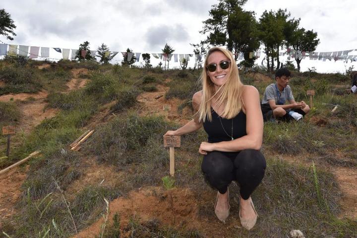 Cassie De Pecol, pictured planting a tree for peace, is the fastest woman to visit every country on earth and the first woman to visit every sovereign nation. (Photo courtesy of Cassie De Pecol)
