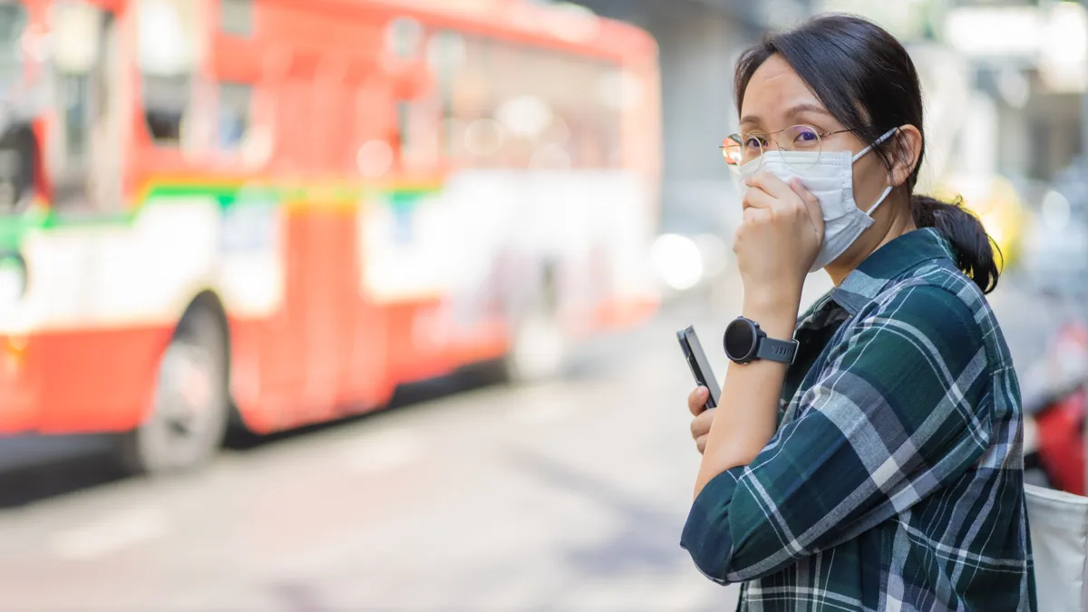 woman mask bus dirty air