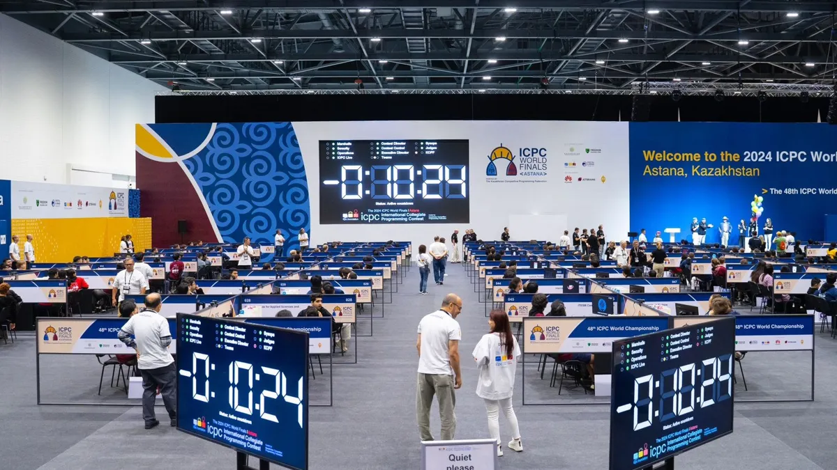 На чемпионате мира по спортивному программированию На чемпионате мира по спортивному программированию, табло с часами и столы с участниками