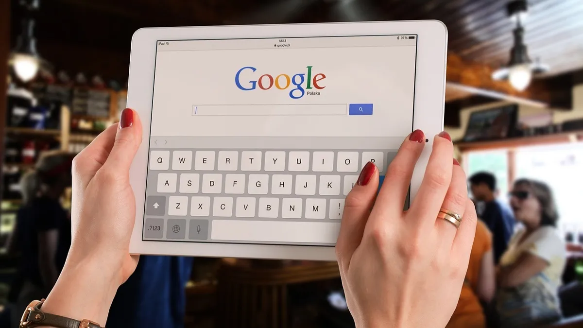 Женские руки держат планшет с надписью Google